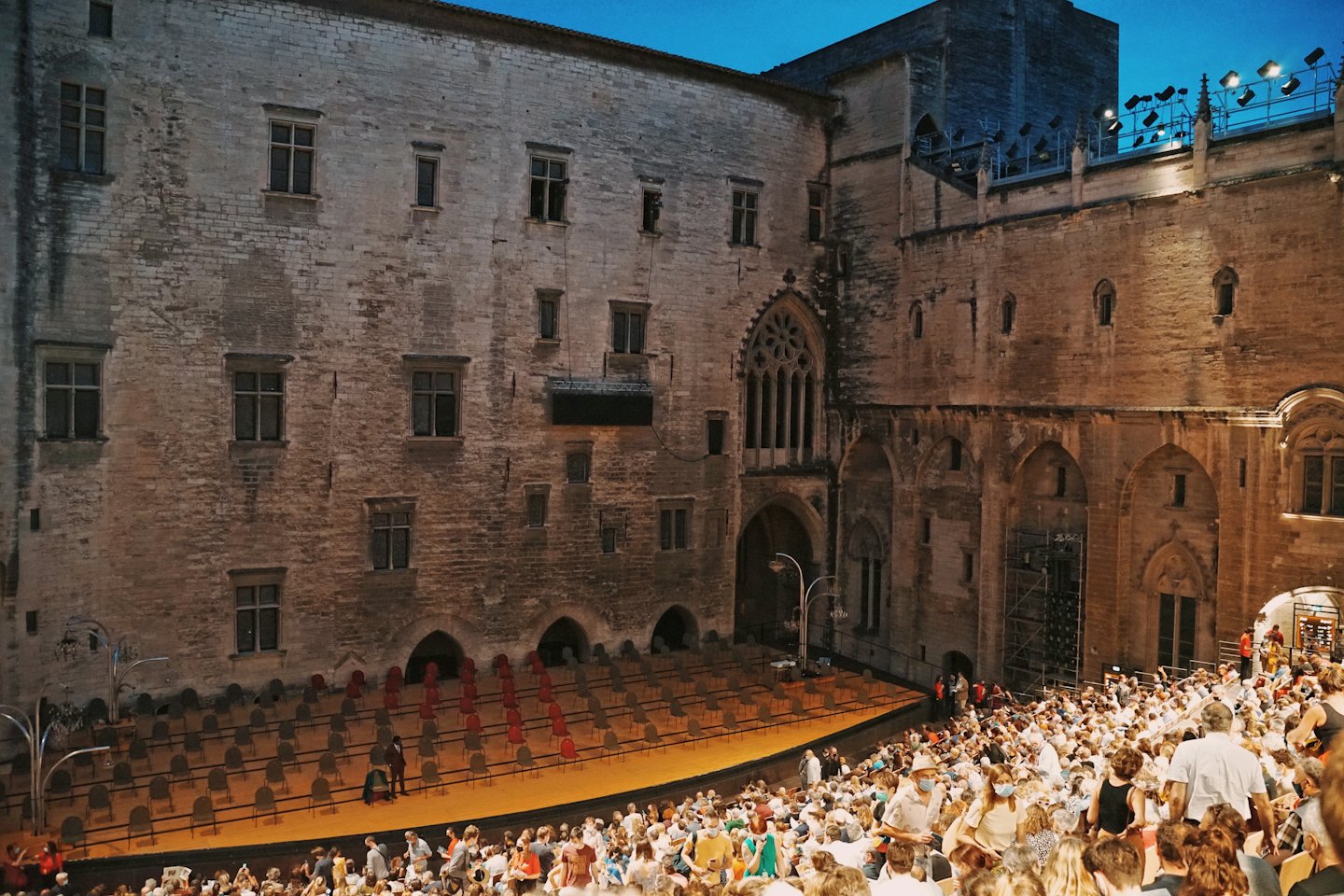 Audience waits for a performance in an ancient stone theater.
